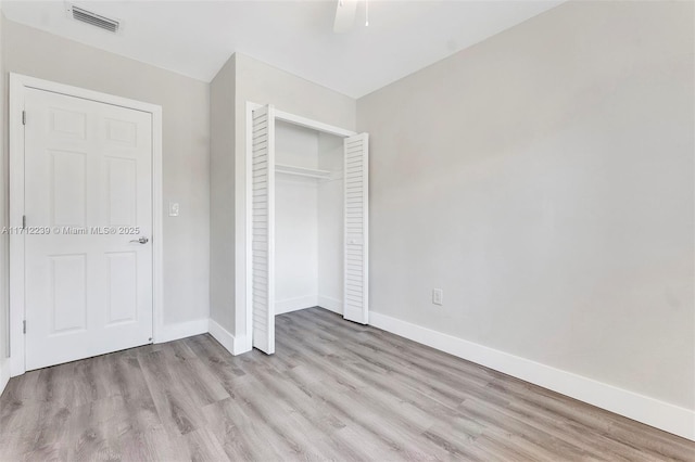 unfurnished bedroom featuring ceiling fan, light hardwood / wood-style flooring, and a closet