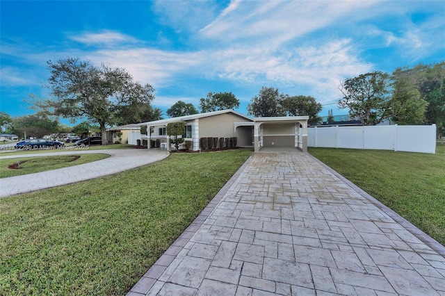 view of front of home with a front lawn and a carport