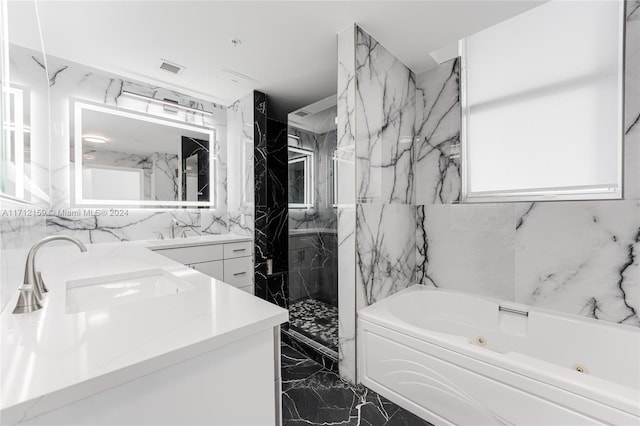 bathroom with vanity, tile walls, and independent shower and bath