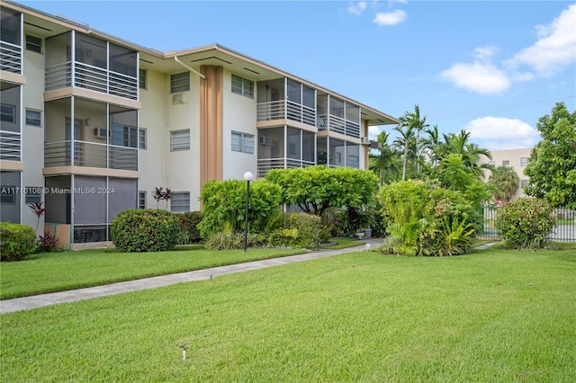 view of property's community with a lawn