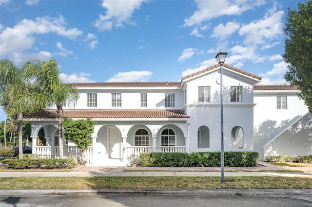 mediterranean / spanish-style house featuring a porch