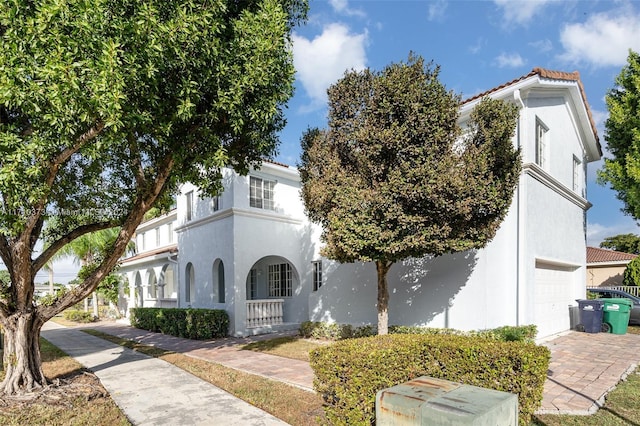 mediterranean / spanish home with a garage