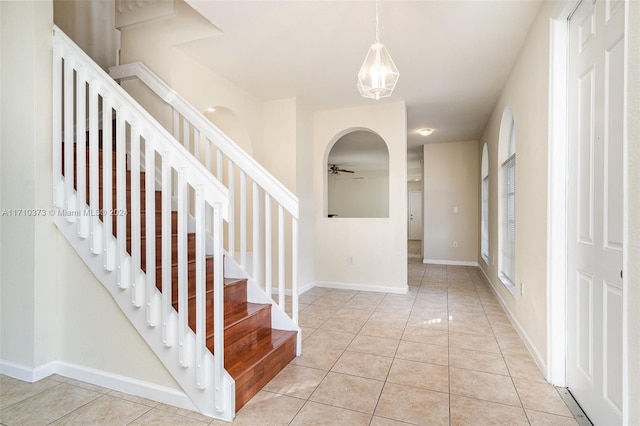 tiled entryway featuring ceiling fan