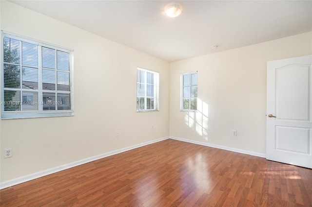 empty room with hardwood / wood-style flooring