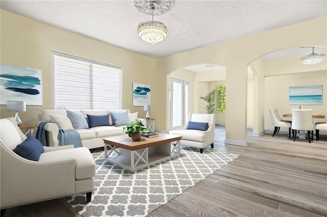 living room featuring a notable chandelier and hardwood / wood-style flooring