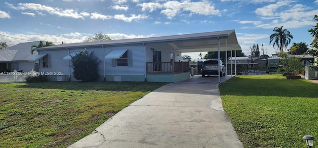 view of front of house featuring crawl space, an attached carport, concrete driveway, and a front lawn