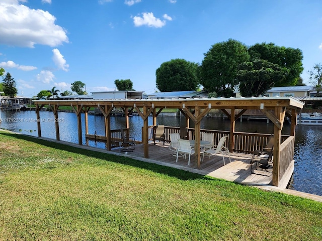 dock area featuring a water view and a yard