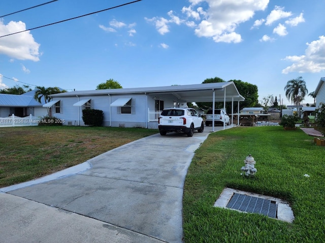 view of front facade featuring a carport and a front yard