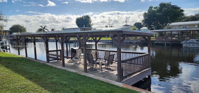 dock area featuring a water view and a lawn