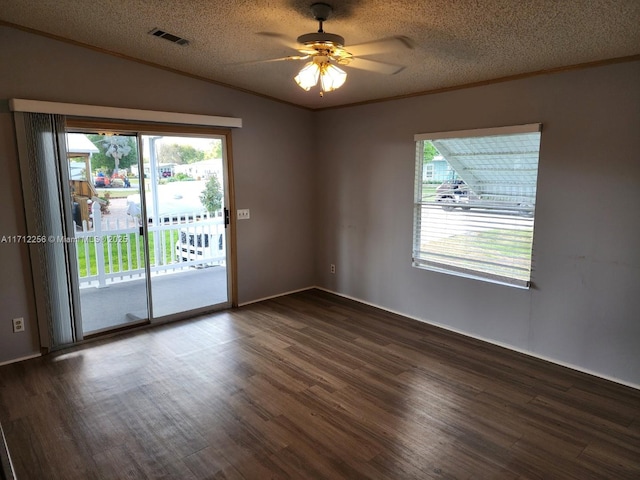 empty room with a textured ceiling, ceiling fan, and a healthy amount of sunlight