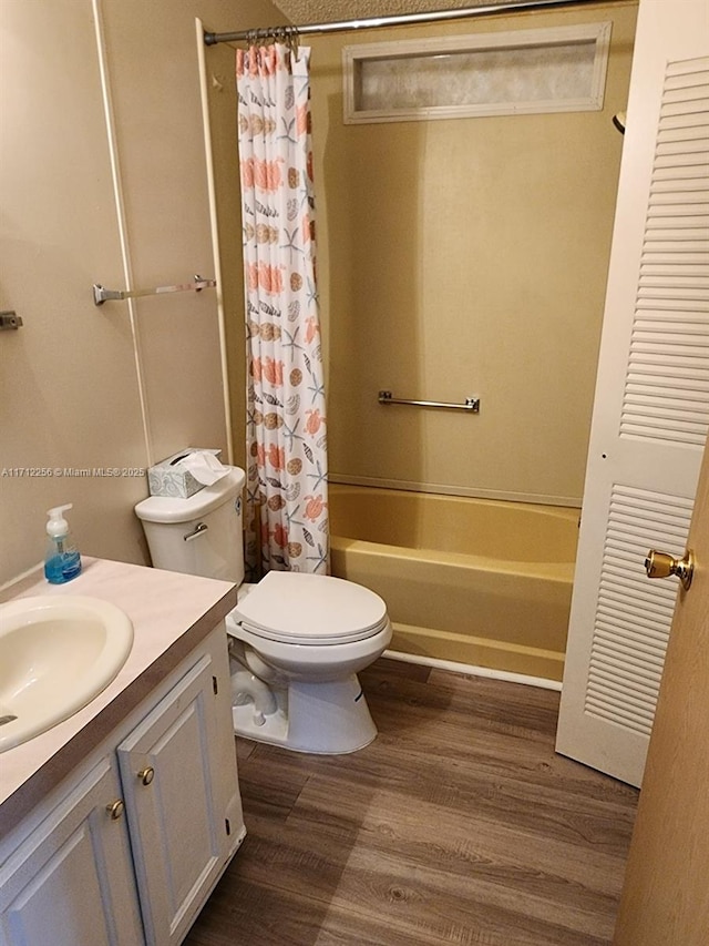 full bathroom with vanity, wood-type flooring, shower / bath combo, and toilet