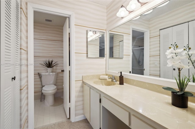 bathroom featuring tile patterned floors, vanity, and toilet