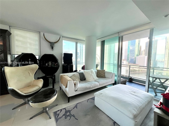 living room featuring a wealth of natural light, tile patterned flooring, and expansive windows