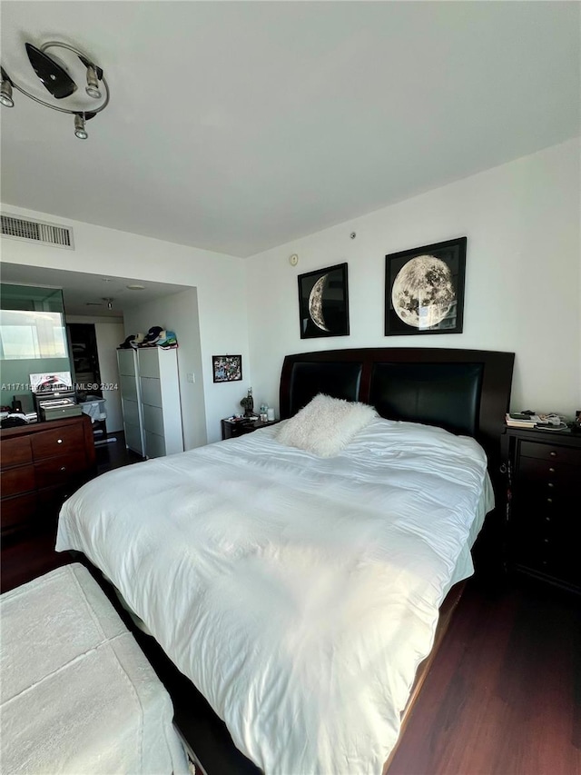 bedroom featuring dark hardwood / wood-style flooring