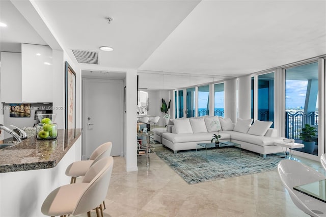 living room with floor to ceiling windows and sink