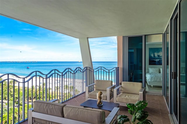 balcony featuring outdoor lounge area and a water view