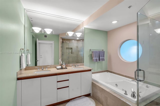 bathroom featuring vanity and shower with separate bathtub