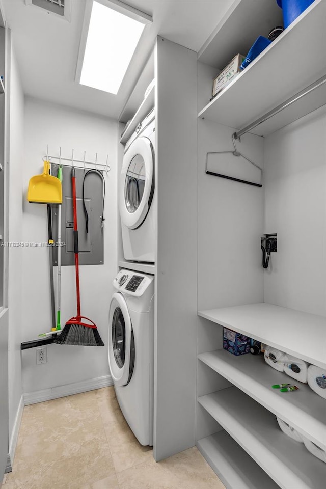 clothes washing area featuring stacked washer / drying machine