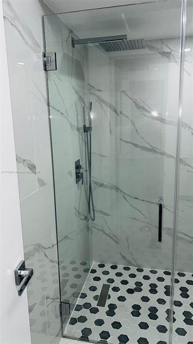 bathroom featuring a shower with shower door