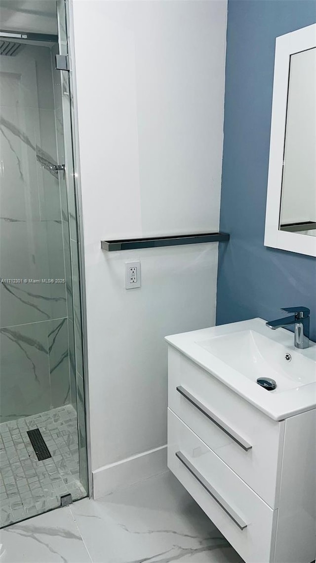 bathroom featuring walk in shower and vanity