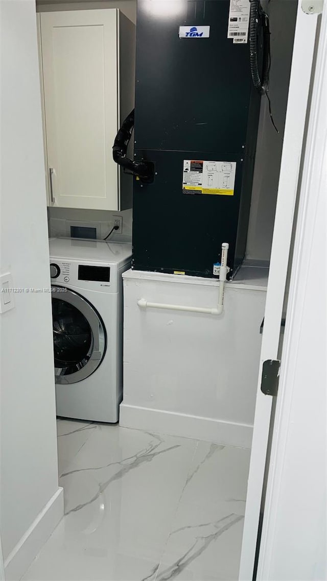 laundry area with cabinets, heating unit, and washer / clothes dryer