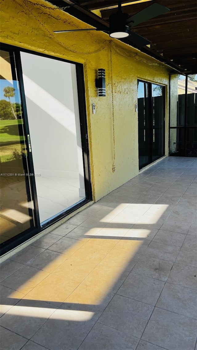 doorway to property featuring ceiling fan and a patio area