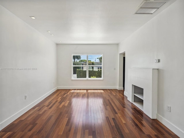 unfurnished living room featuring dark hardwood / wood-style floors