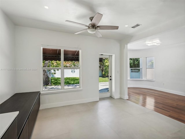 empty room with ceiling fan and light wood-type flooring