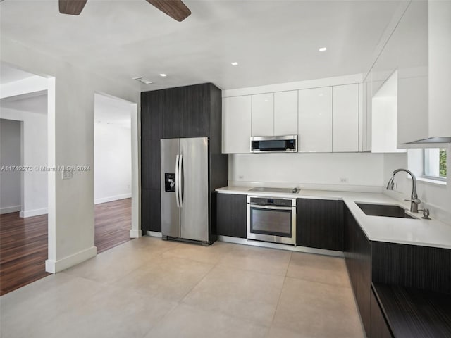 kitchen with ceiling fan, sink, stainless steel appliances, light hardwood / wood-style floors, and white cabinets