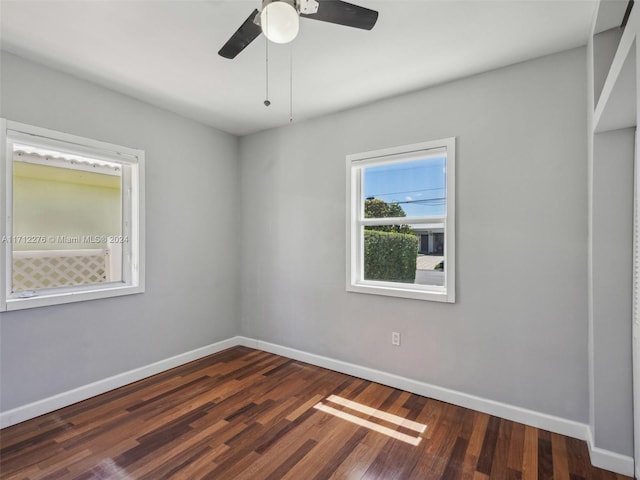 spare room with ceiling fan and dark hardwood / wood-style flooring