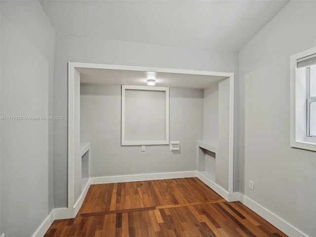 laundry area featuring wood-type flooring