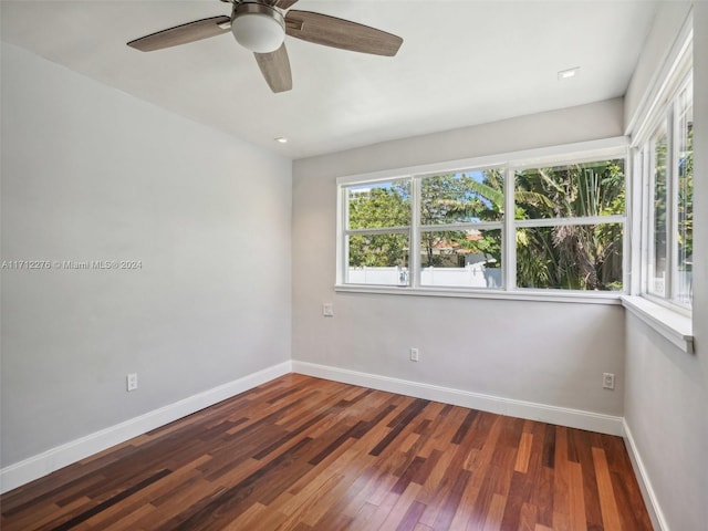 unfurnished room featuring dark hardwood / wood-style flooring and ceiling fan