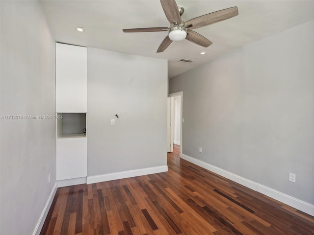 spare room with dark hardwood / wood-style floors and ceiling fan