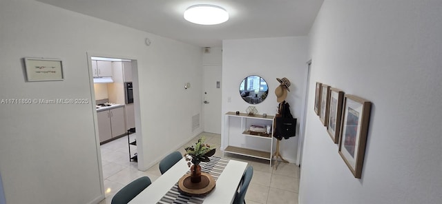 hall featuring light tile patterned flooring