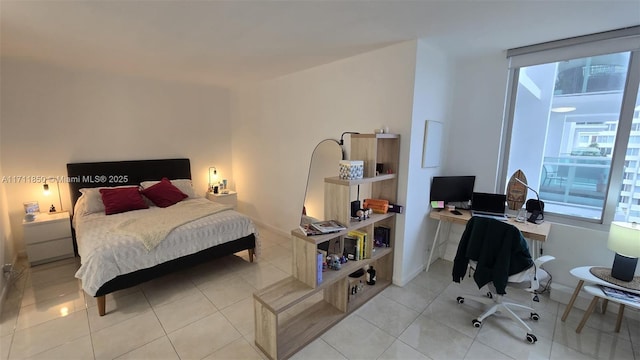 bedroom with light tile patterned floors