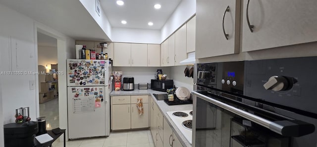 kitchen featuring light tile patterned flooring, white cabinetry, and black appliances