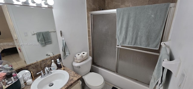 full bathroom with toilet, vanity, and combined bath / shower with glass door