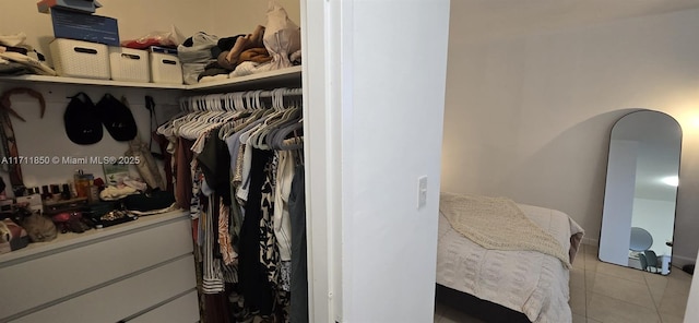 spacious closet with light tile patterned floors