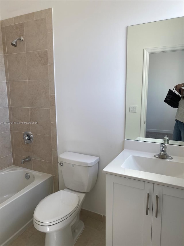 full bathroom featuring tile patterned flooring, vanity, toilet, and tiled shower / bath