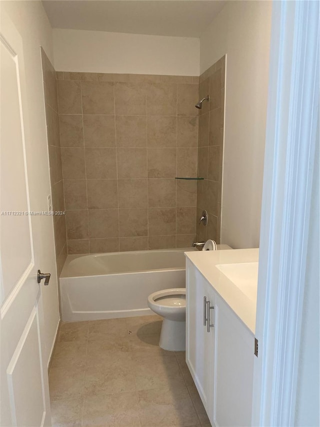 full bathroom featuring tile patterned flooring, vanity, tiled shower / bath combo, and toilet