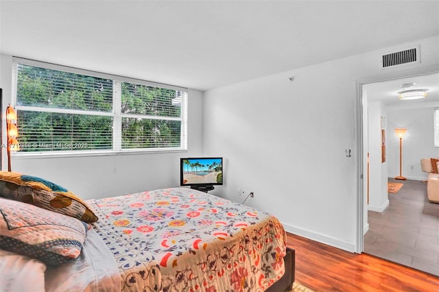 bedroom with hardwood / wood-style flooring