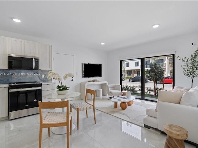 living room featuring marble finish floor, a fireplace, and recessed lighting