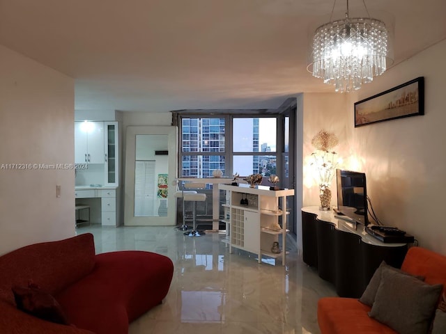 living room with a chandelier and a wall of windows