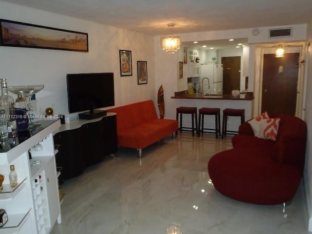 living room with sink and an inviting chandelier