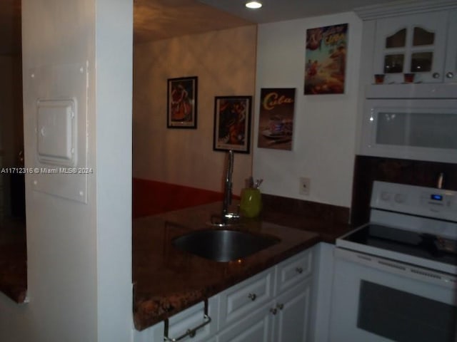 kitchen with white cabinets, white appliances, and sink