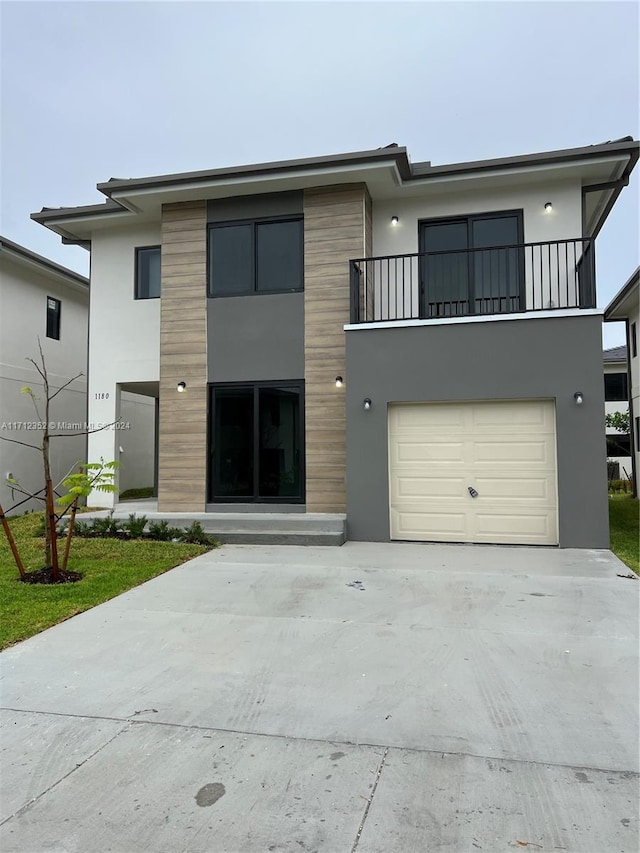 view of front of property featuring a balcony and a garage