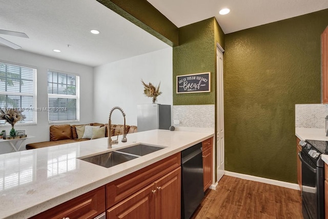 kitchen with dark hardwood / wood-style flooring, ceiling fan, sink, and black appliances