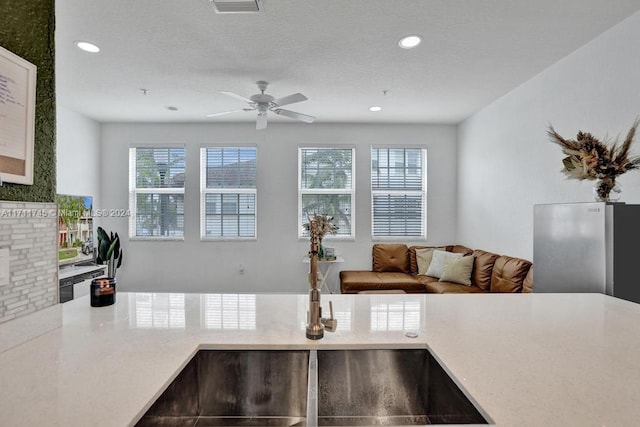 kitchen featuring stainless steel fridge and ceiling fan