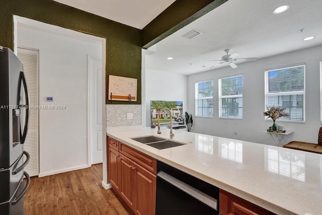 kitchen with ceiling fan, dishwasher, sink, stainless steel fridge with ice dispenser, and light hardwood / wood-style flooring