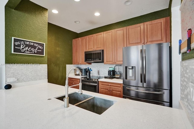 kitchen featuring backsplash, stainless steel appliances, and sink